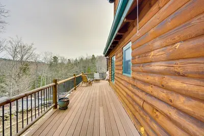a wooden deck on the side of a house at Massachusetts Vacation Rental with Deck and Grill in Cheshire