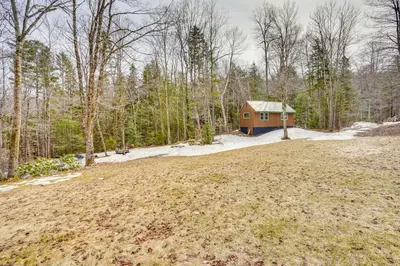 a small house in the middle of a field at Massachusetts Vacation Rental with Deck and Grill in Cheshire