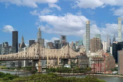 a bridge over a river with a city in the background at Residence Inn by Marriott New York Queens in Queens