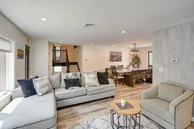 a living room with two couches and a dining room at 6 Mi to Hunter Mtn Winter Retreat with Hot Tub! in Tannersville