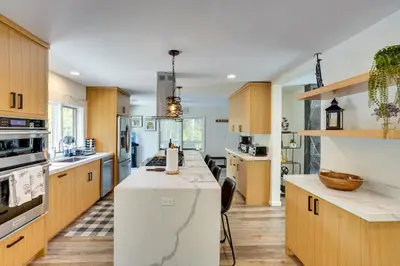a kitchen with wooden cabinets and a white counter top at 6 Mi to Hunter Mtn Winter Retreat with Hot Tub! in Tannersville