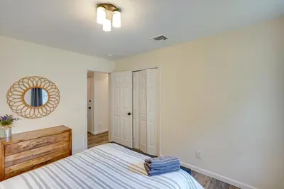 a bedroom with a bed and a mirror on the wall at 6 Mi to Hunter Mtn Winter Retreat with Hot Tub! in Tannersville