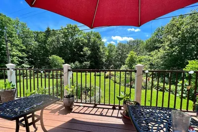a patio with an umbrella and a table and chairs at Mid-Century DJs Dream near Rhinebeck in Staatsburg