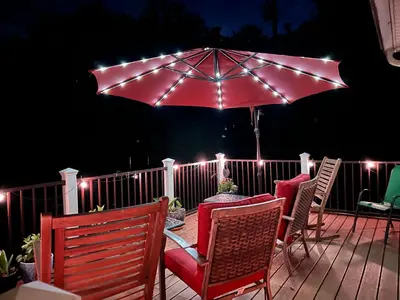 a patio with a table and chairs and an umbrella at Mid-Century DJs Dream near Rhinebeck in Staatsburg