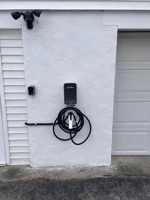 a white wall with a black hose attached to a garage at Mid-Century DJs Dream near Rhinebeck in Staatsburg