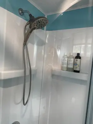 a shower with a shower head in a bathroom at Mid-Century DJs Dream near Rhinebeck in Staatsburg