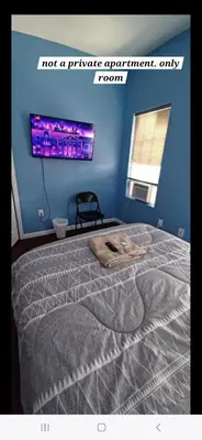 a bedroom with a bed with a blue wall at Willoughby in Newark