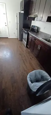 a kitchen with a trash can in the middle of a room at Willoughby in Newark