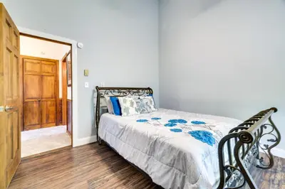 a bedroom with a bed and a wooden floor at Exciting Tobyhanna Home Near Kalahari Water Park! in Tobyhanna