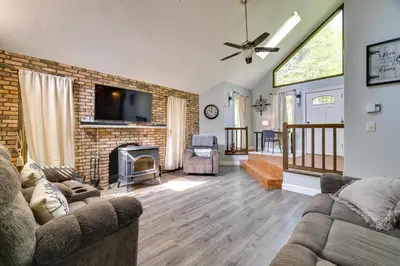 a living room with a couch and a fireplace at Exciting Tobyhanna Home Near Kalahari Water Park! in Tobyhanna