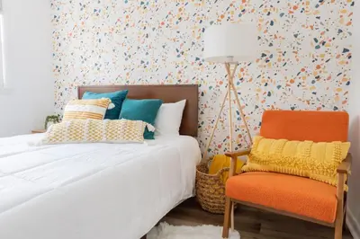a bedroom with a bed and a chair at Retro Retreat renovated 2BR, desk, no chore list! in Kingston