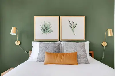 a bedroom with a bed with three pictures on the wall at Tribeca Studio w Pool Roofdeck Gym View NYC-273 in New York