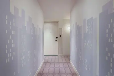an empty hallway with a door and a pink tile floor at Motto By Hilton New York City Times Square in New York