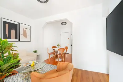 a living room with a glass table and chairs at 444-3E Contemporary 1BR in Hell's Kitchen in New York