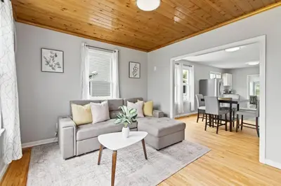 a living room with a couch and a table at Stylish, Relaxing & Comfy 3 BDR Home in Bristol