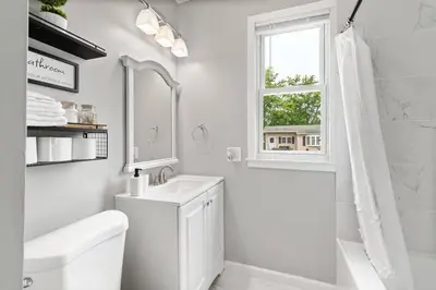 a white bathroom with a sink and a window at Stylish, Relaxing & Comfy 3 BDR Home in Bristol