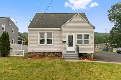 a small white house with a porch at Stylish, Relaxing & Comfy 3 BDR Home in Bristol