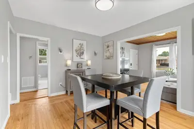 a dining room with a black table and chairs at Stylish, Relaxing & Comfy 3 BDR Home in Bristol