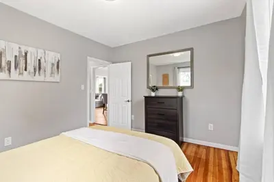 a white bedroom with a bed and a mirror at Stylish, Relaxing & Comfy 3 BDR Home in Bristol