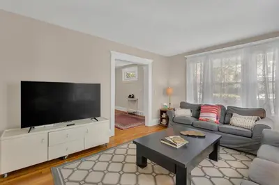 a living room with a large flat screen tv at Charming New England Home in West Hartford Center in West Hartford