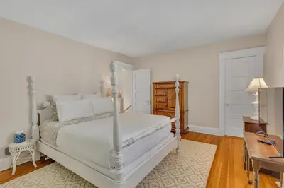 a bedroom with a white bed and a desk at Charming New England Home in West Hartford Center in West Hartford