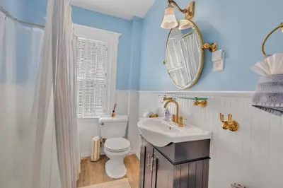 a bathroom with a sink and a toilet and a mirror at Charming New England Home in West Hartford Center in West Hartford