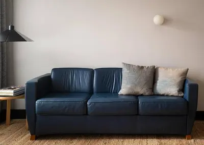 a blue couch in a living room with a table at Elegant Townhouse, Hudson center, 3 ensuite baths in Hudson