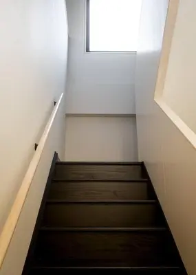 a staircase in a room with a window at Elegant Townhouse, Hudson center, 3 ensuite baths in Hudson