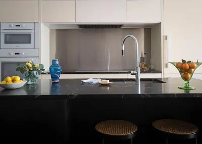 a kitchen counter with a sink and a bowl of fruit at Elegant Townhouse, Hudson center, 3 ensuite baths in Hudson