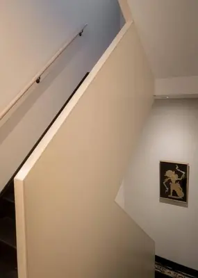 a room with a white staircase with a painting on the wall at Elegant Townhouse, Hudson center, 3 ensuite baths in Hudson