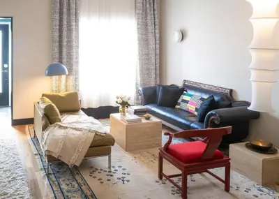 a living room with a couch and a chair at Elegant Townhouse, Hudson center, 3 ensuite baths in Hudson