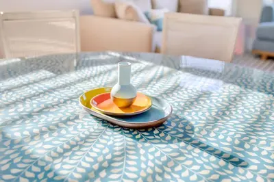 a vase on a plate on a table at SkyHouse JC - New 3BR Apt with Private Rooftop in Jersey City