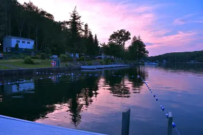a body of water with a sunset in the background at Chestnut Inn at Oquaga Lake in Deposit