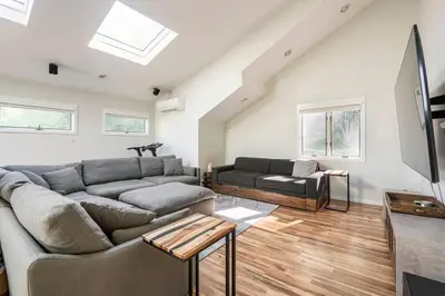 a living room with a couch and a tv at Modern, Cozy Hudson Valley Escape 1 Hr From NYC in Putnam Valley