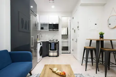 a living room with a blue couch and a table at 78-3C Newly renovated 1BR WD Walk 2 Central Park in New York