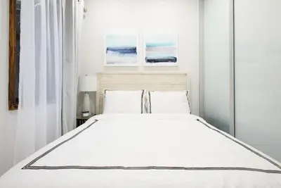 a bedroom with a large bed with white sheets and pillows at 78-3C Newly renovated 1BR WD Walk 2 Central Park in New York