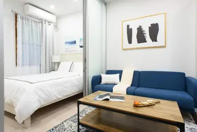 a living room with a blue couch and a bed at 78-3C Newly renovated 1BR WD Walk 2 Central Park in New York