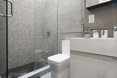 a bathroom with a toilet and a glass shower at 78-3C Newly renovated 1BR WD Walk 2 Central Park in New York