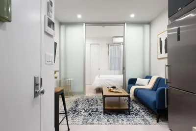 a living room with a blue couch and a table at 78-3C Newly renovated 1BR WD Walk 2 Central Park in New York