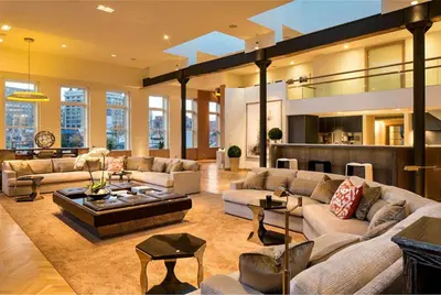 a large living room with couches and a table at Rasila SoHo in New York