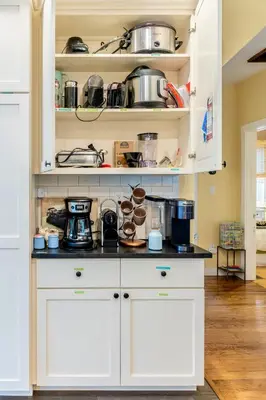 a kitchen with white cabinets with pots and pans at 1890 CapeCod farmhouse:Charming, Private, Spacious in Saugerties