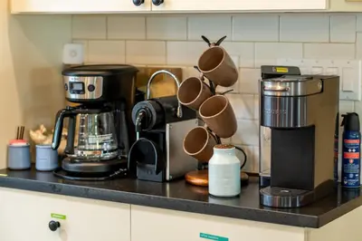 a kitchen counter with a coffeemaker and a coffee maker at 1890 CapeCod farmhouse:Charming, Private, Spacious in Saugerties
