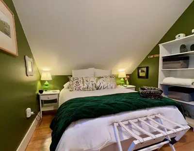 a bedroom with green walls and a large bed at 1890 CapeCod farmhouse:Charming, Private, Spacious in Saugerties