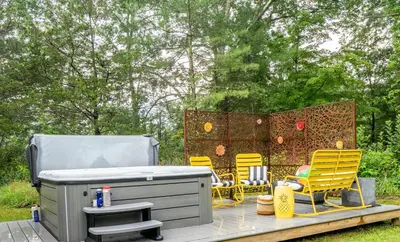 a group of chairs and a grill on a patio at 1890 CapeCod farmhouse:Charming, Private, Spacious in Saugerties