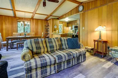 a living room with a couch and a table at Gouldsboro Vacation Rental with Pool and Lake Access! in Gouldsboro