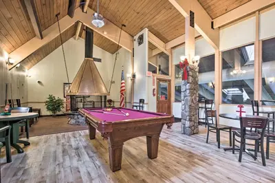 a pool table in a room with a fireplace at Gouldsboro Vacation Rental with Pool and Lake Access! in Gouldsboro