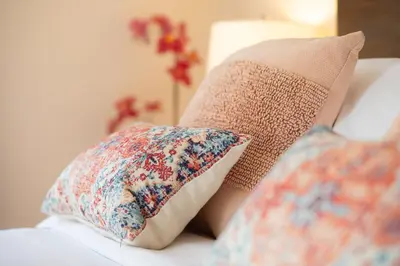 two pillows are sitting on a white couch at Entire House Right In Stamford's Heart in Stamford