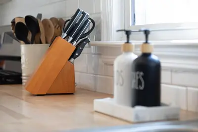 a kitchen counter with two bottles and a knife block at Entire House Right In Stamford's Heart in Stamford