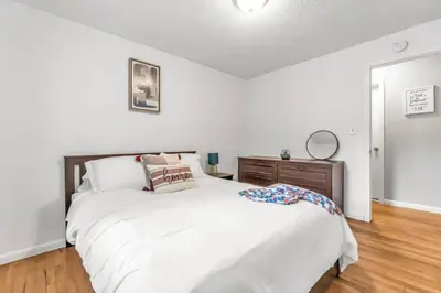 a white bedroom with a large bed and a dresser at North Haven Charm, 3BD Yale Retreat in North Haven