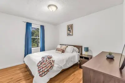 a bedroom with a bed and a desk and a window at North Haven Charm, 3BD Yale Retreat in North Haven